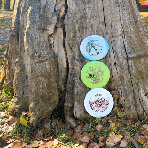 Beginner Bundle - Stratosphere, Dream, and Pursue discs leaning against a tree